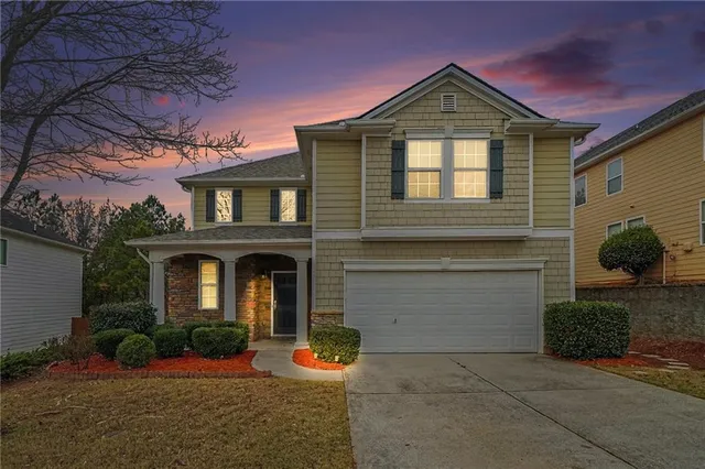 a front view of a house with garden
