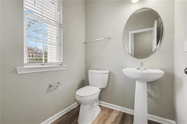 a bathroom with a toilet a sink and a mirror