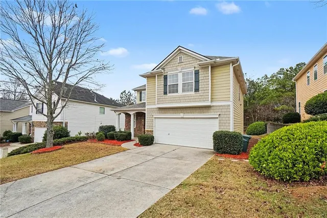 a front view of a house with a yard