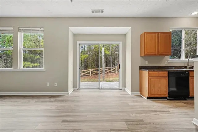 a view of a kitchen with a sink and a large window