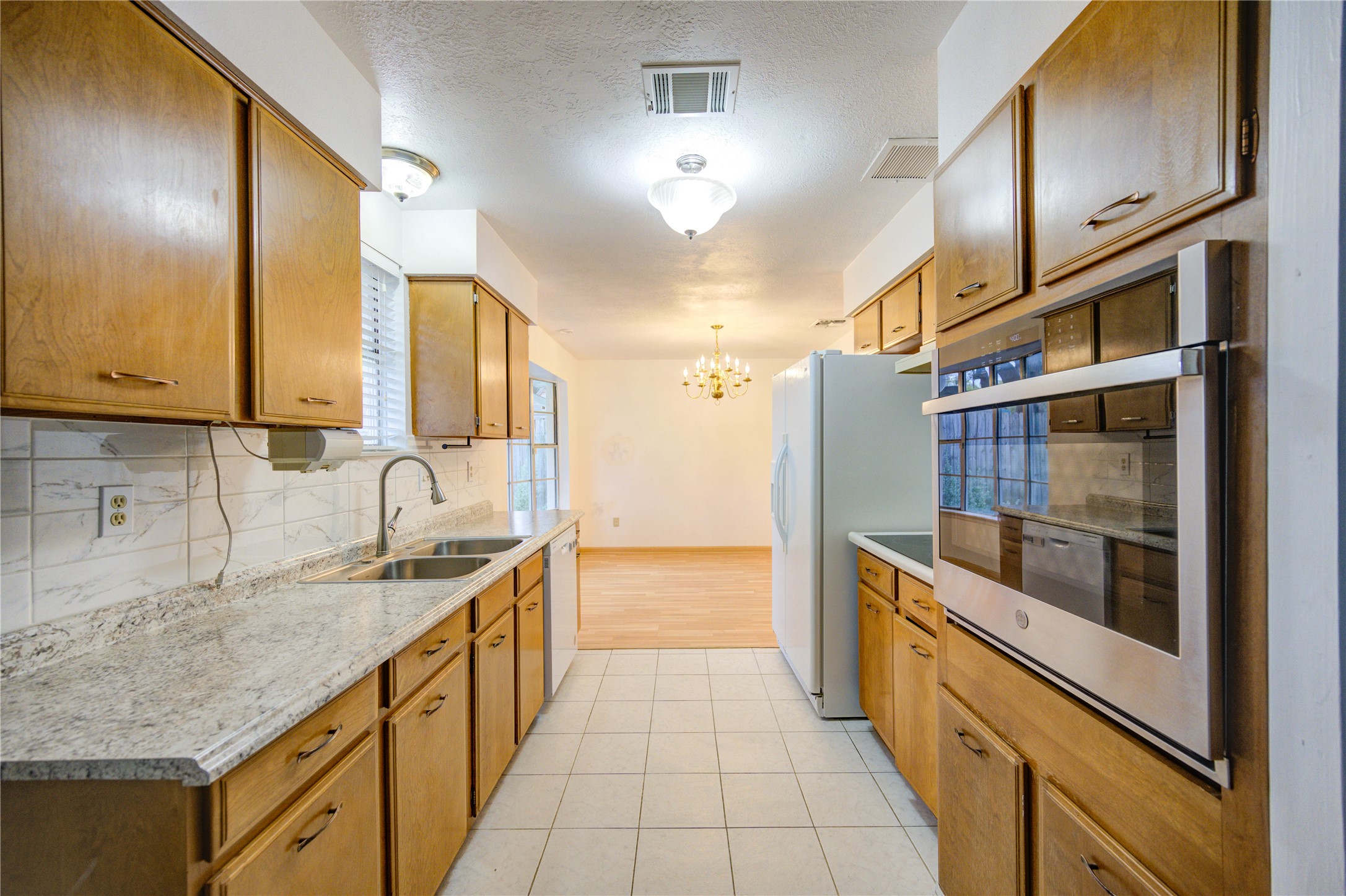 10823 Radford Lane Houston, TX 77031 - Photo 7 of 18 a kitchen with stainless steel appliances granite countertop a sink and cabinets