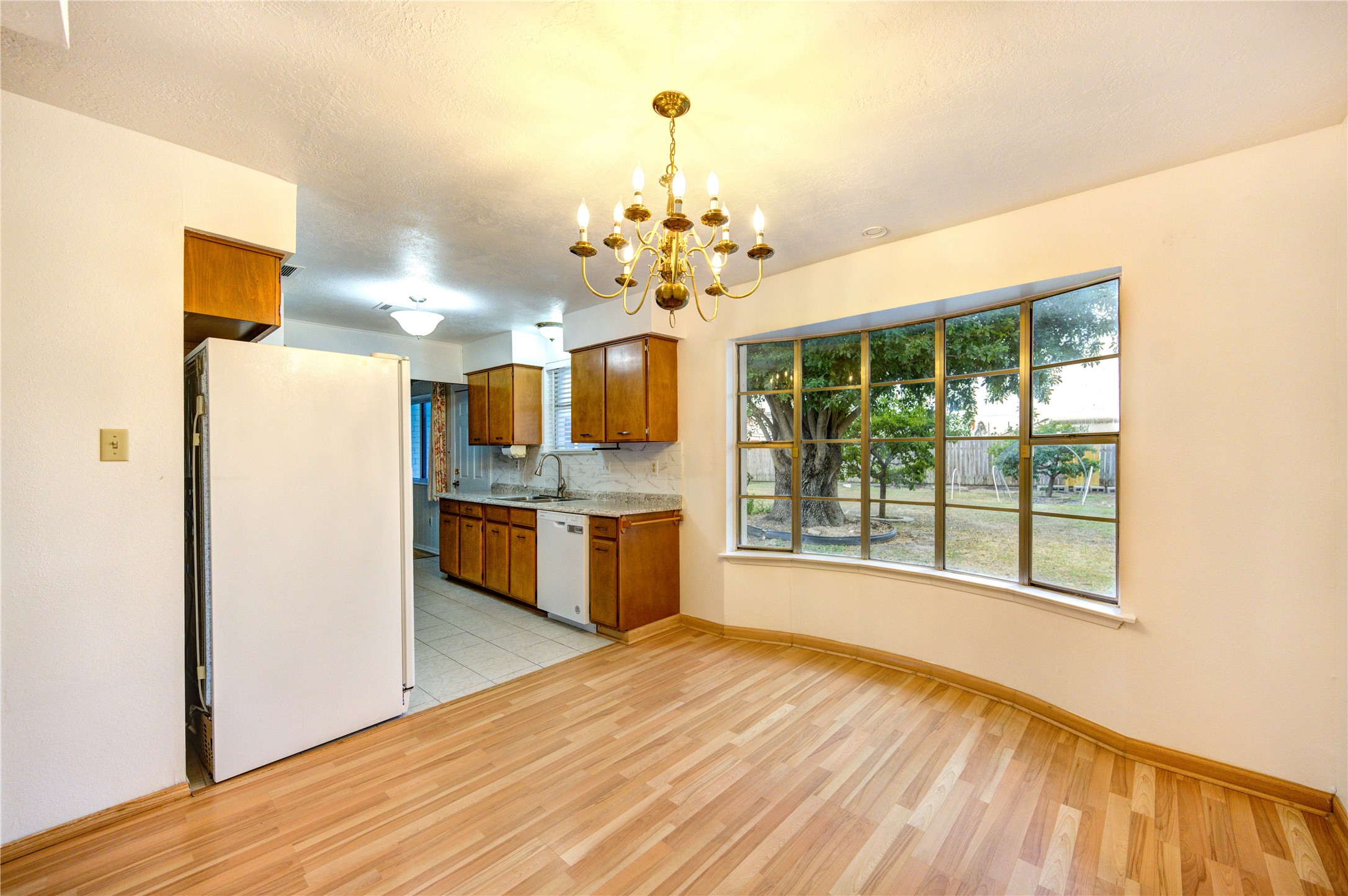 10823 Radford Lane Houston, TX 77031 - Photo 10 of 18 a view of a kitchen with a sink and dishwasher with wooden floor