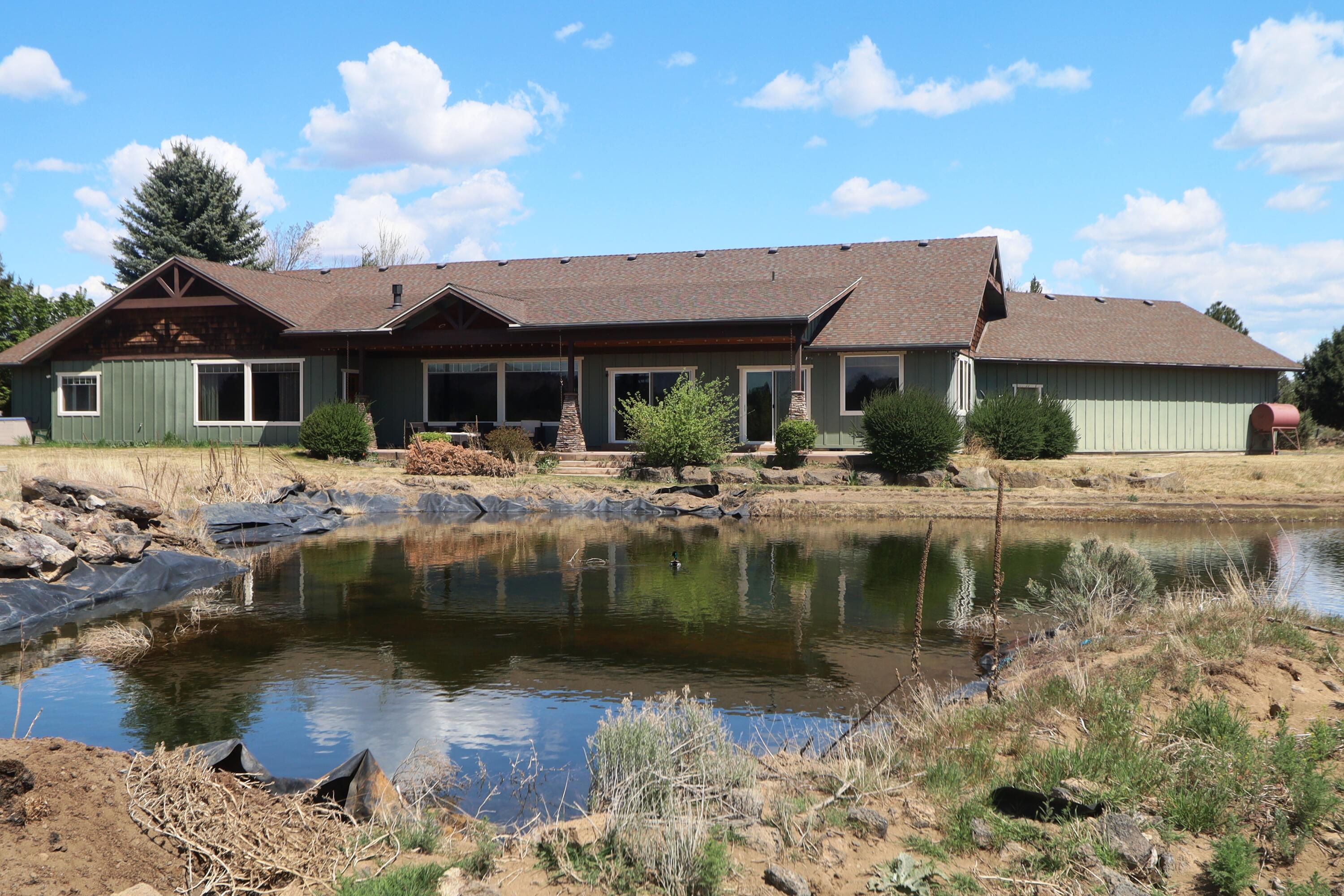 21491 Bear Creek Road Bend, OR 97701 - Photo 4 of 45 a front view of a house with swimming pool