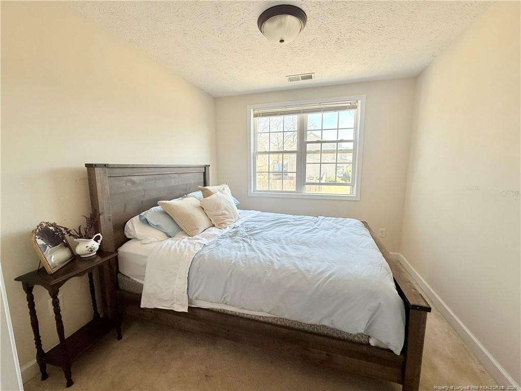 234 Pender Road Spring Lake, NC 28390 - Photo 25 of 39 a large bed sitting in a bedroom next to a window
