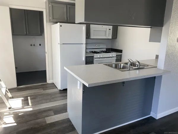 a kitchen with a refrigerator and a sink