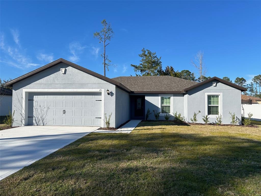 15 Rivera Lane Palm Coast, FL 32164 - Photo 1 of 1 a front view of a house with a yard