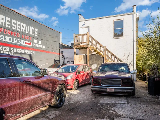 a view of cars parked in front of a house