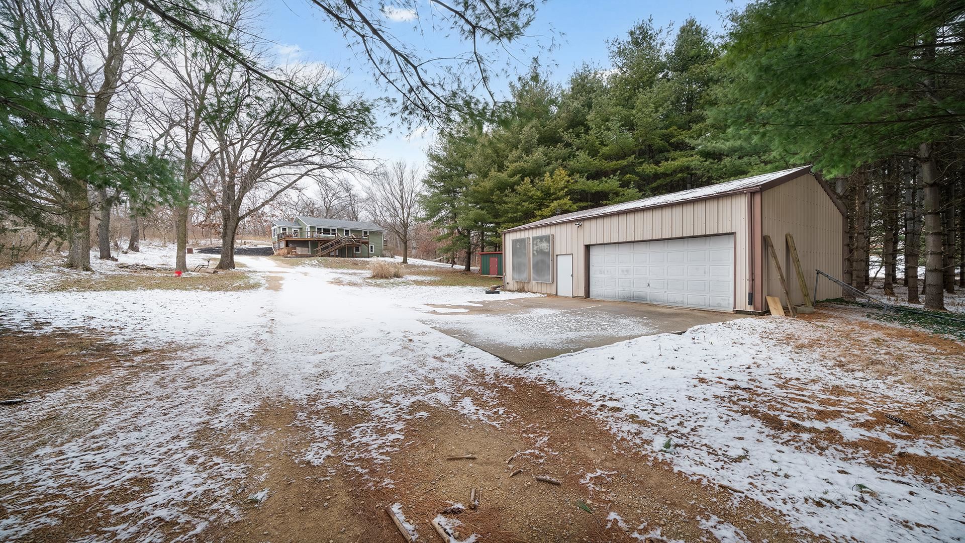 2063 Grand Detour Road Dixon, IL 61021 - Photo 2 of 44 a backyard of a house with large trees and a wooden fence
