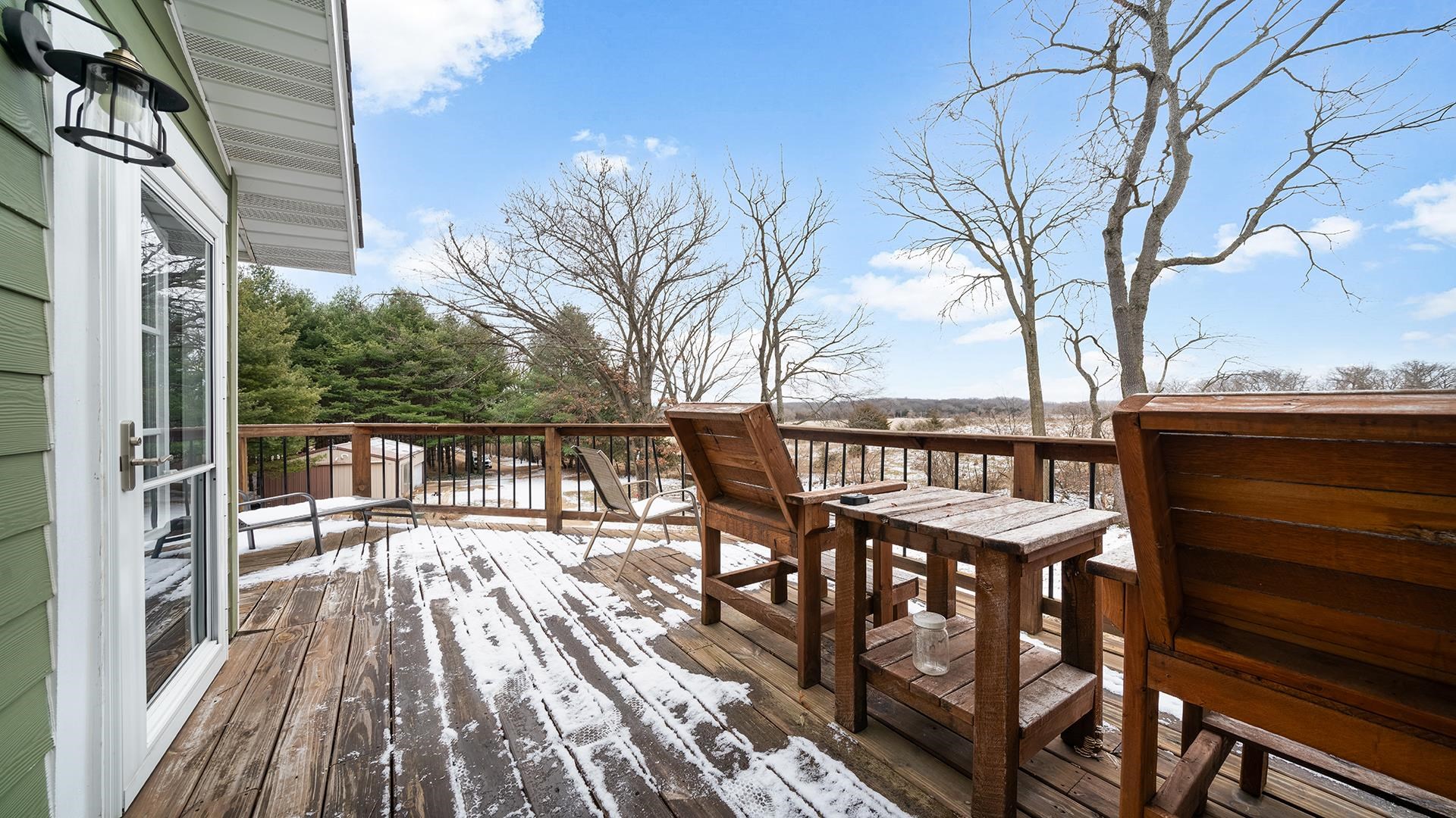 2063 Grand Detour Road Dixon, IL 61021 - Photo 31 of 44 a balcony with wooden floor table and chairs