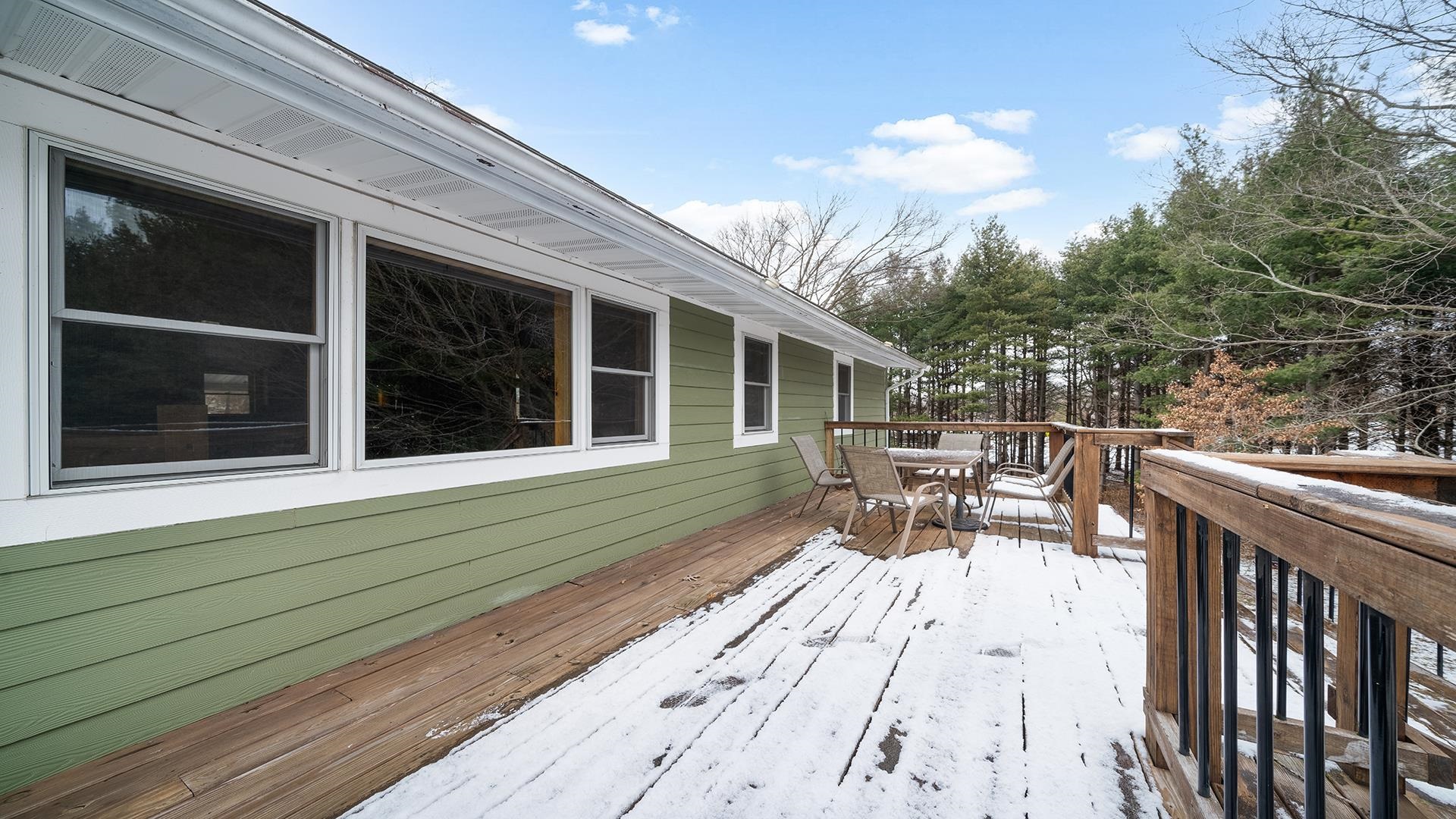 2063 Grand Detour Road Dixon, IL 61021 - Photo 32 of 44 a view of a patio with table and chairs with wooden floor and fence