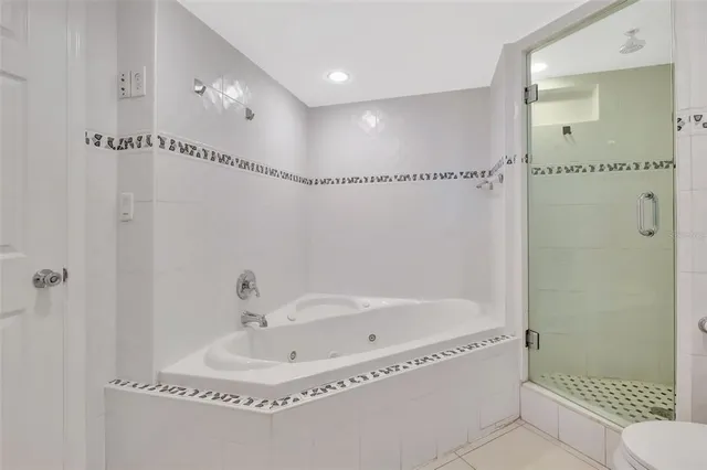 a bathroom with a tub and a shower