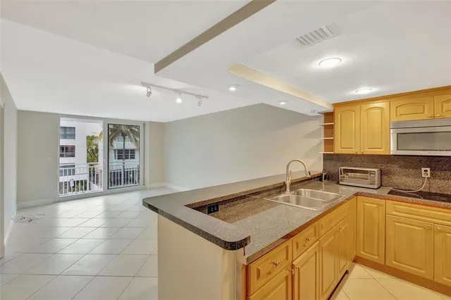 a kitchen with a sink a counter top space and cabinets