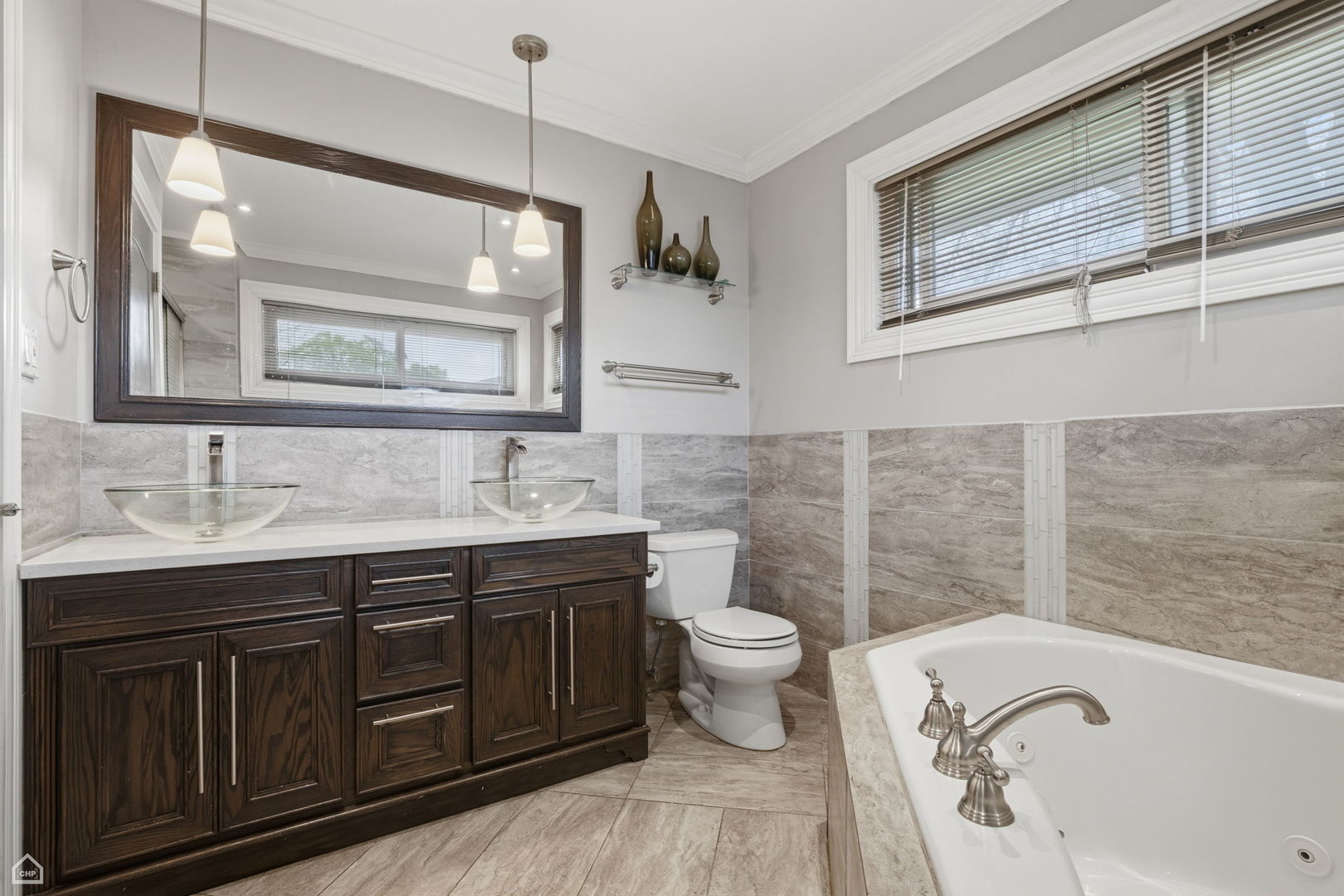 7301 Davis Street Morton Grove, IL 60053 - Photo 6 of 14 a bathroom with a granite countertop toilet a sink and a bathtub