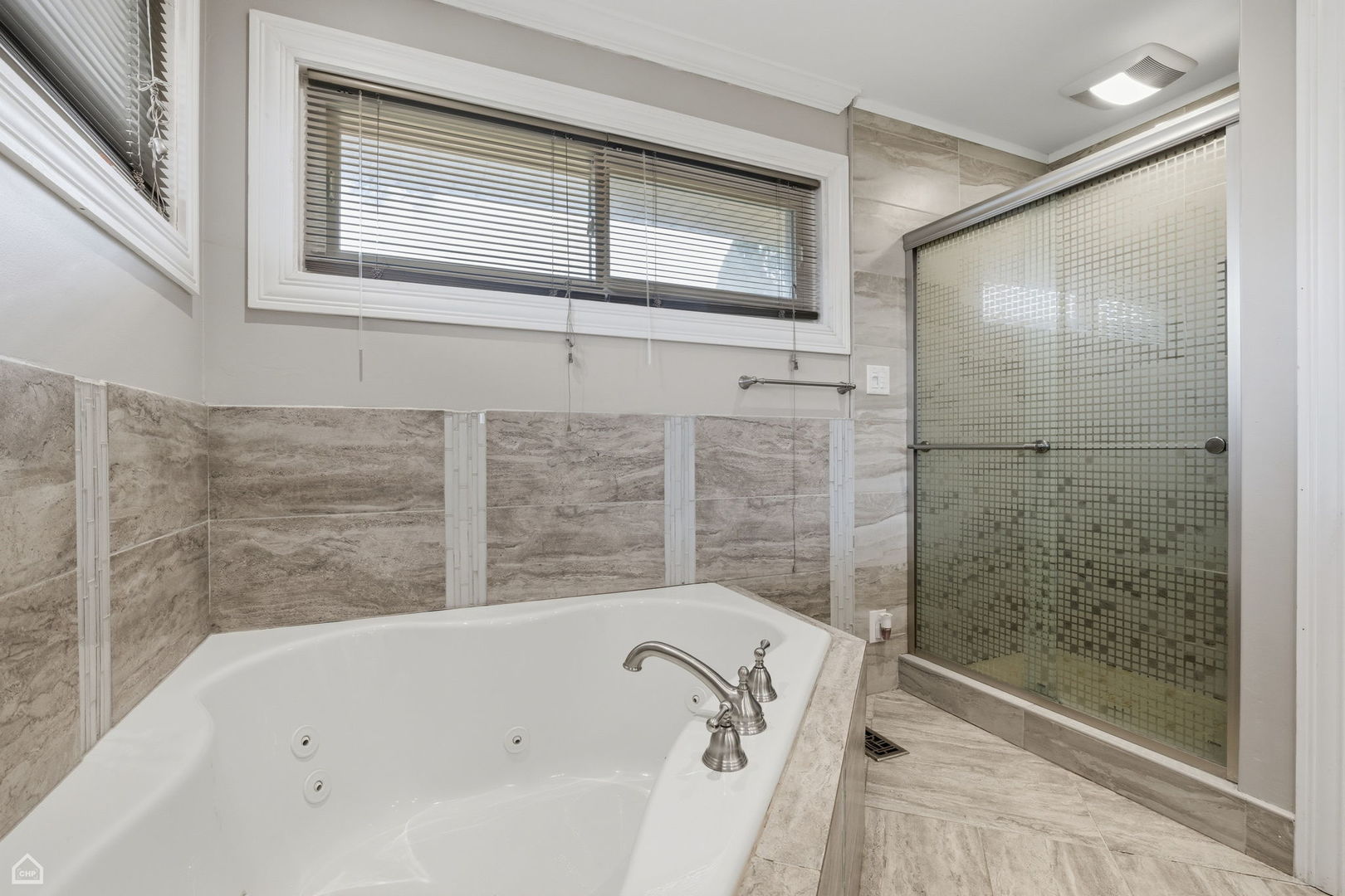 7301 Davis Street Morton Grove, IL 60053 - Photo 8 of 14 a bathroom with a bathtub and shower