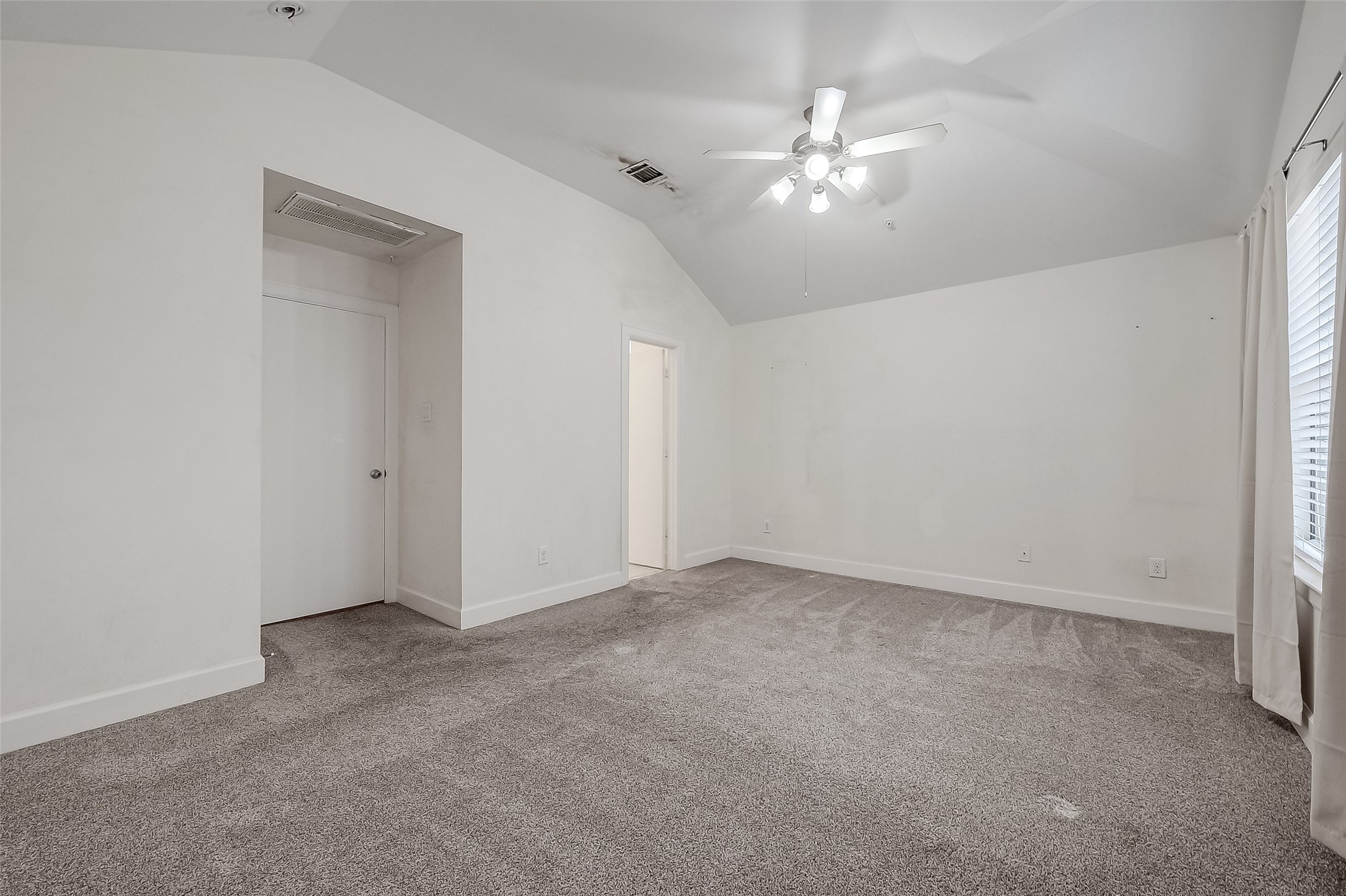 2710 Hullsmith Drive, Unit 1503 Houston, TX 77063 - Photo 11 of 14 an empty room with a chandelier fan and windows