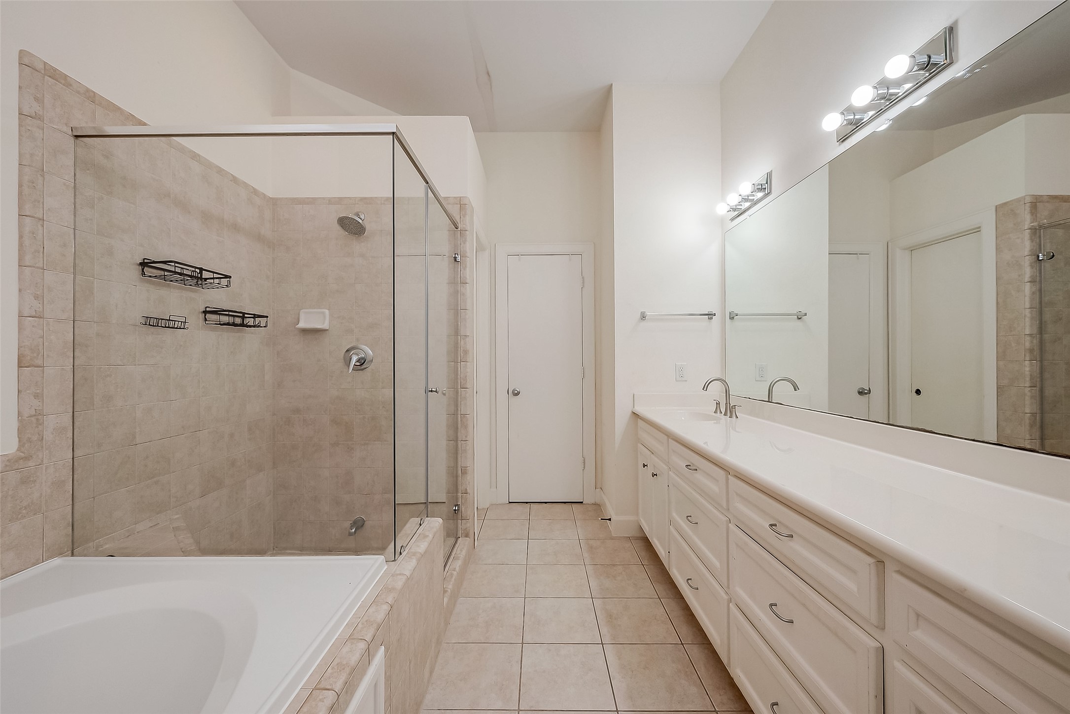 2710 Hullsmith Drive, Unit 1503 Houston, TX 77063 - Photo 12 of 14 a spacious bathroom with a tub sink shower and mirror