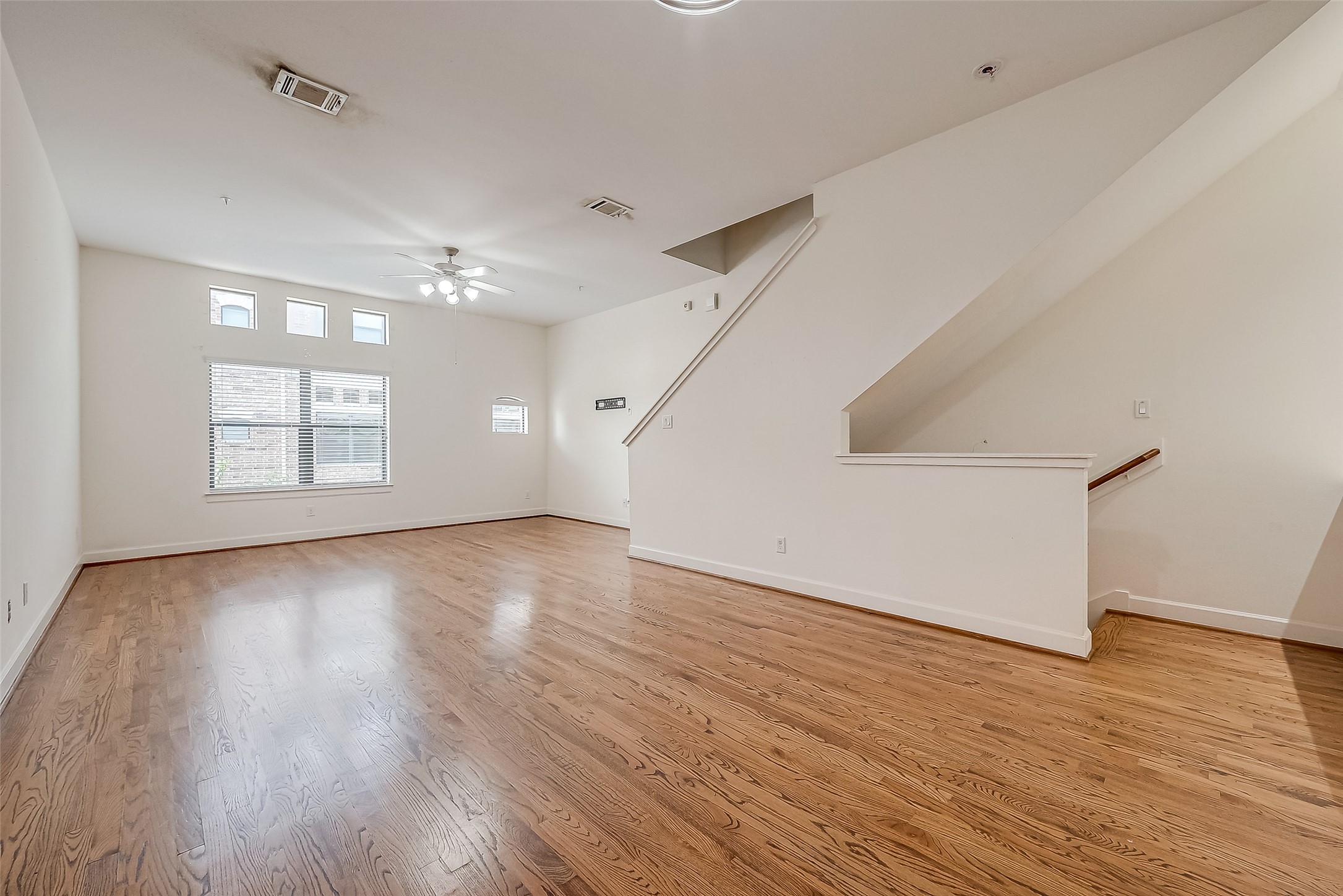 2710 Hullsmith Drive, Unit 1503 Houston, TX 77063 - Photo 5 of 14 a view of an empty room with wooden floor and a window