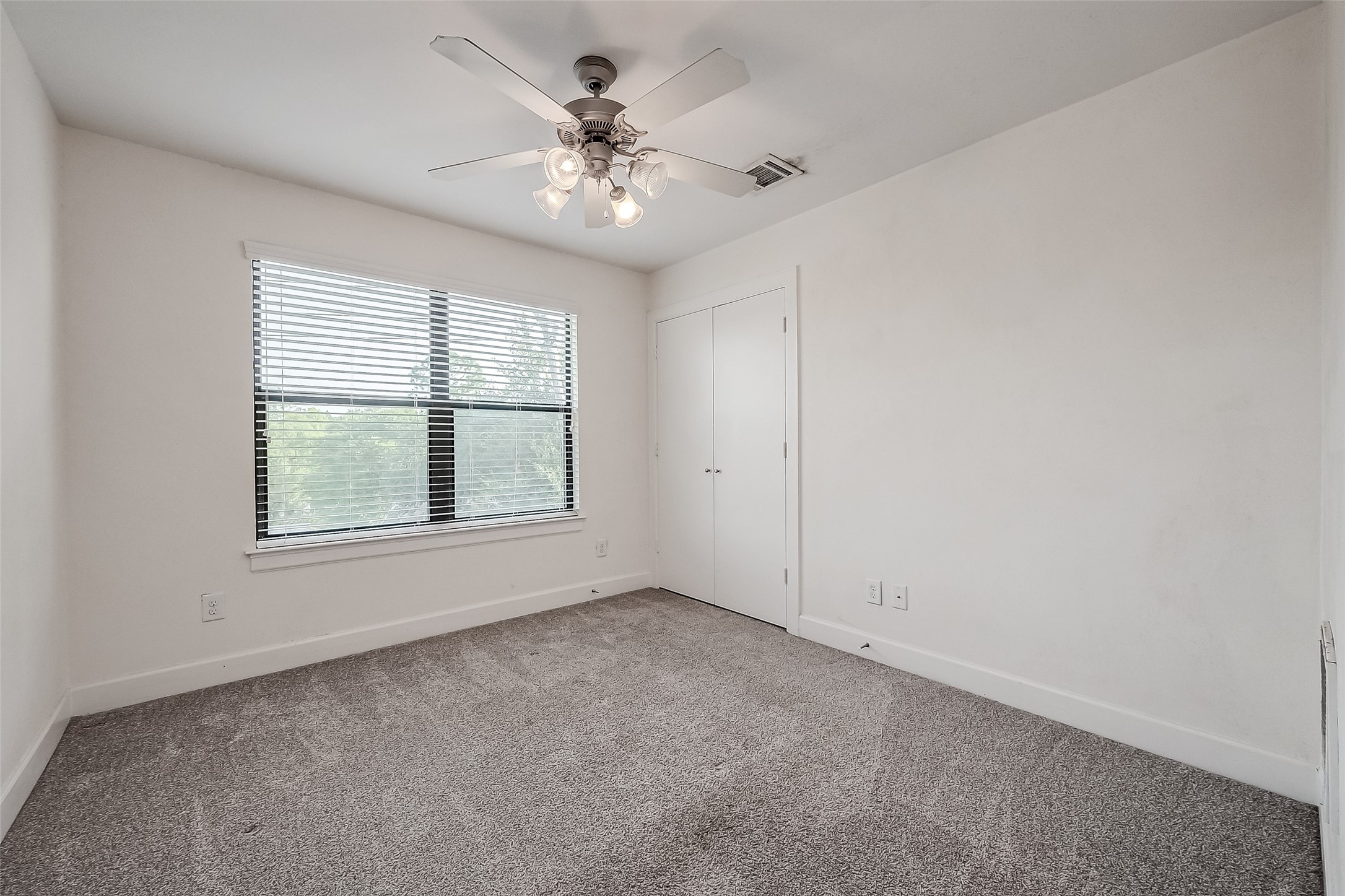 2710 Hullsmith Drive, Unit 1503 Houston, TX 77063 - Photo 10 of 14 an empty room with chandelier fan and windows