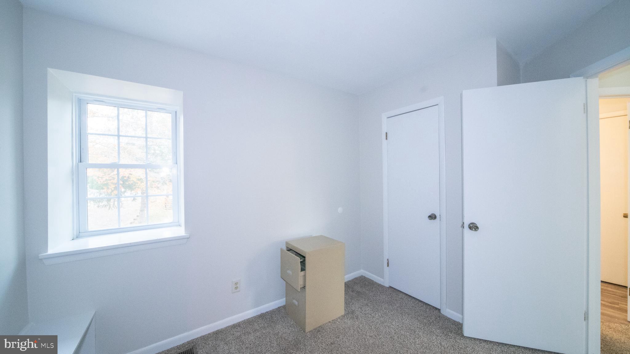 593 Riverside Drive Pasadena, MD 21122 - Photo 13 of 25 a view of an empty room with a window