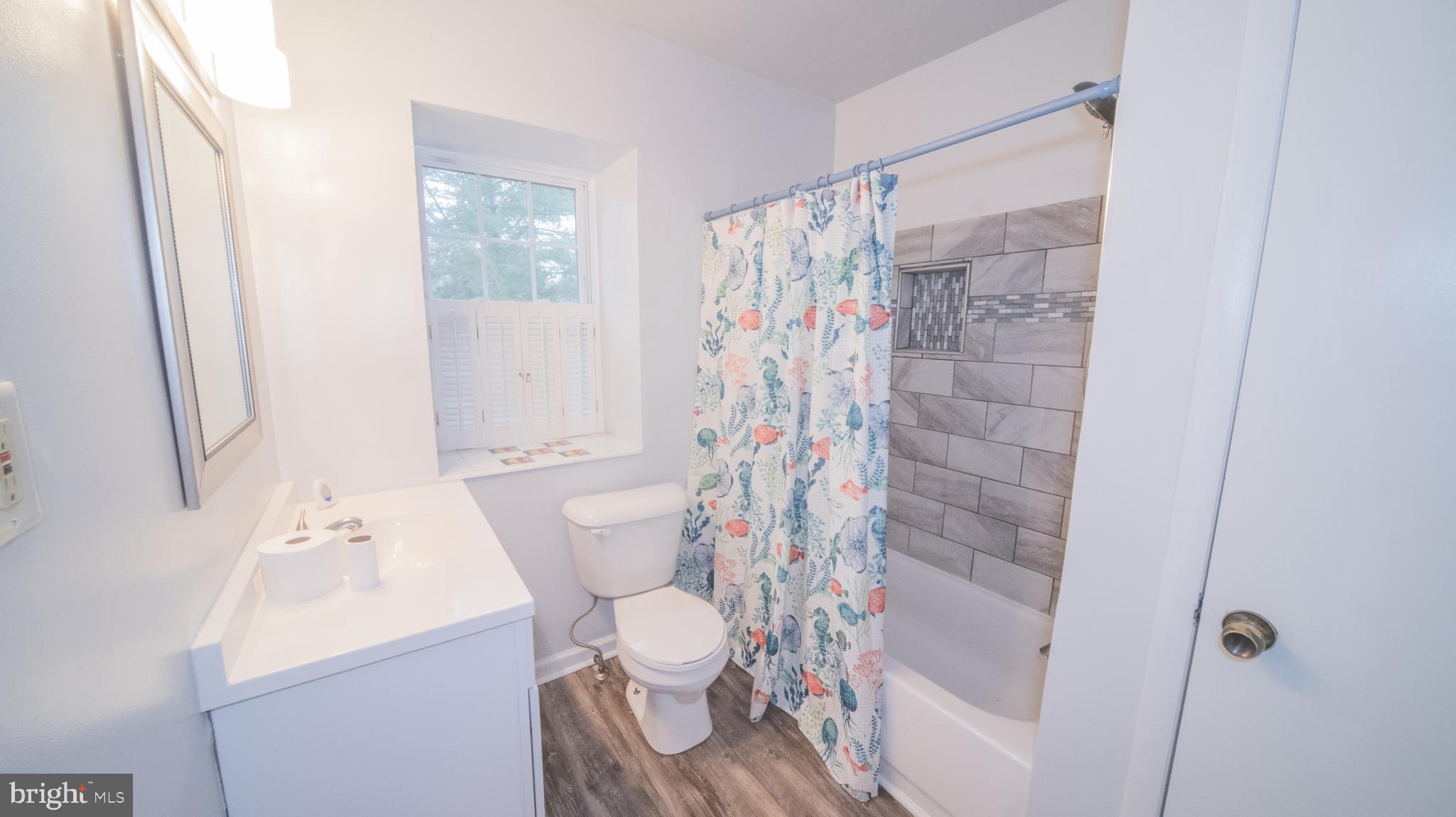 593 Riverside Drive Pasadena, MD 21122 - Photo 15 of 26 a bathroom with a sink toilet and shower