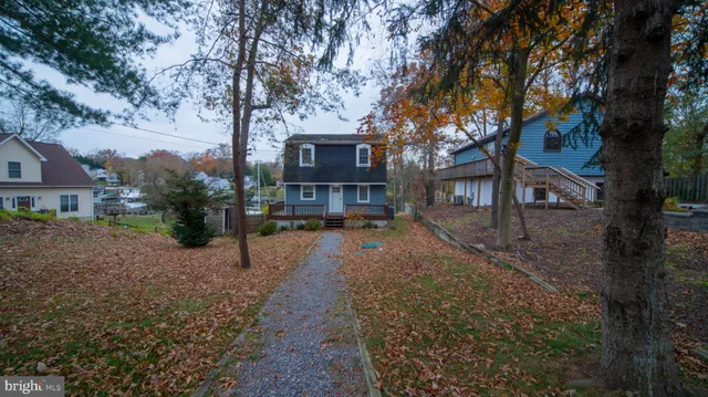 a view of a house with a yard covered in snow