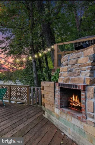a view of deck with wooden floor and a fireplace