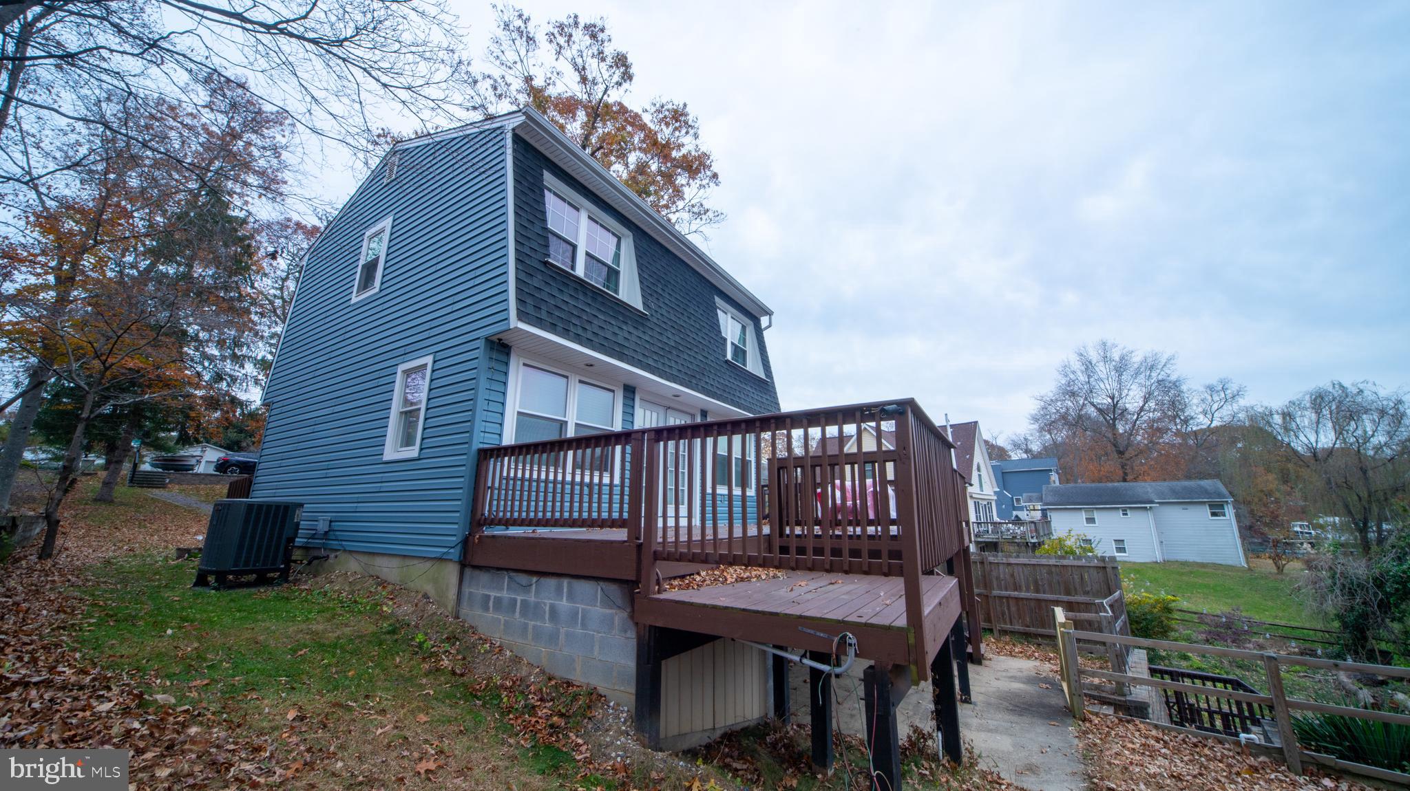 593 Riverside Drive Pasadena, MD 21122 - Photo 23 of 26 a view of a deck with furniture and a yard