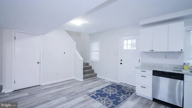 a view of a kitchen with wooden floor and electronic appliances