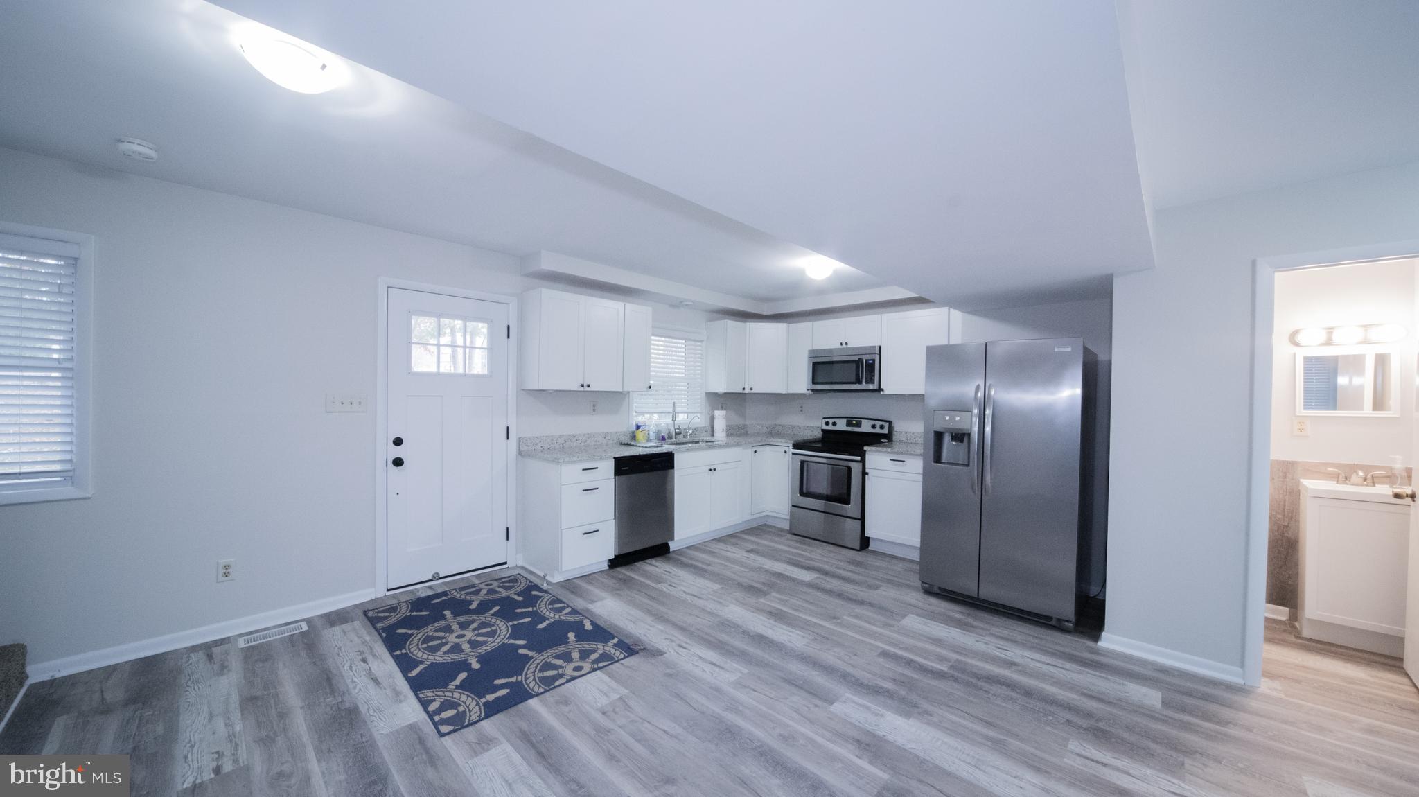 593 Riverside Drive Pasadena, MD 21122 - Photo 8 of 26 a kitchen with granite countertop a refrigerator and a sink