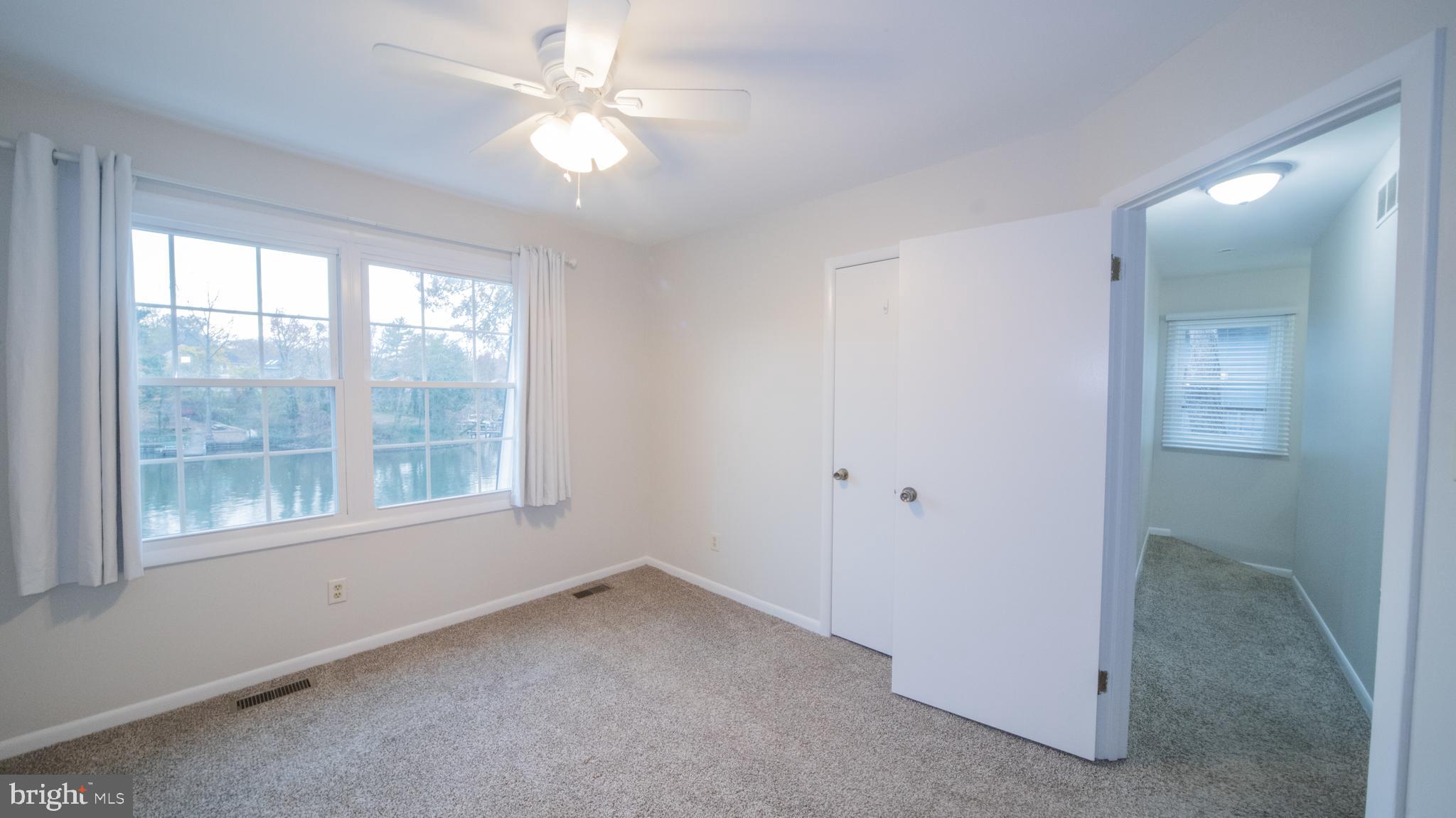 593 Riverside Drive Pasadena, MD 21122 - Photo 10 of 25 a view of a big room with windows and chandelier fan