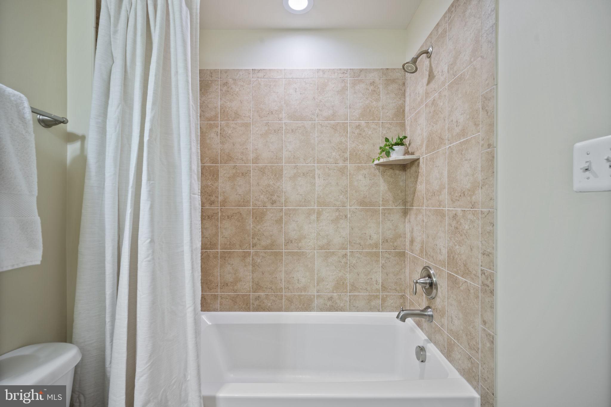 8976 Tawes Street Fulton, MD 20759 - Photo 15 of 65 a bathroom with a bathtub