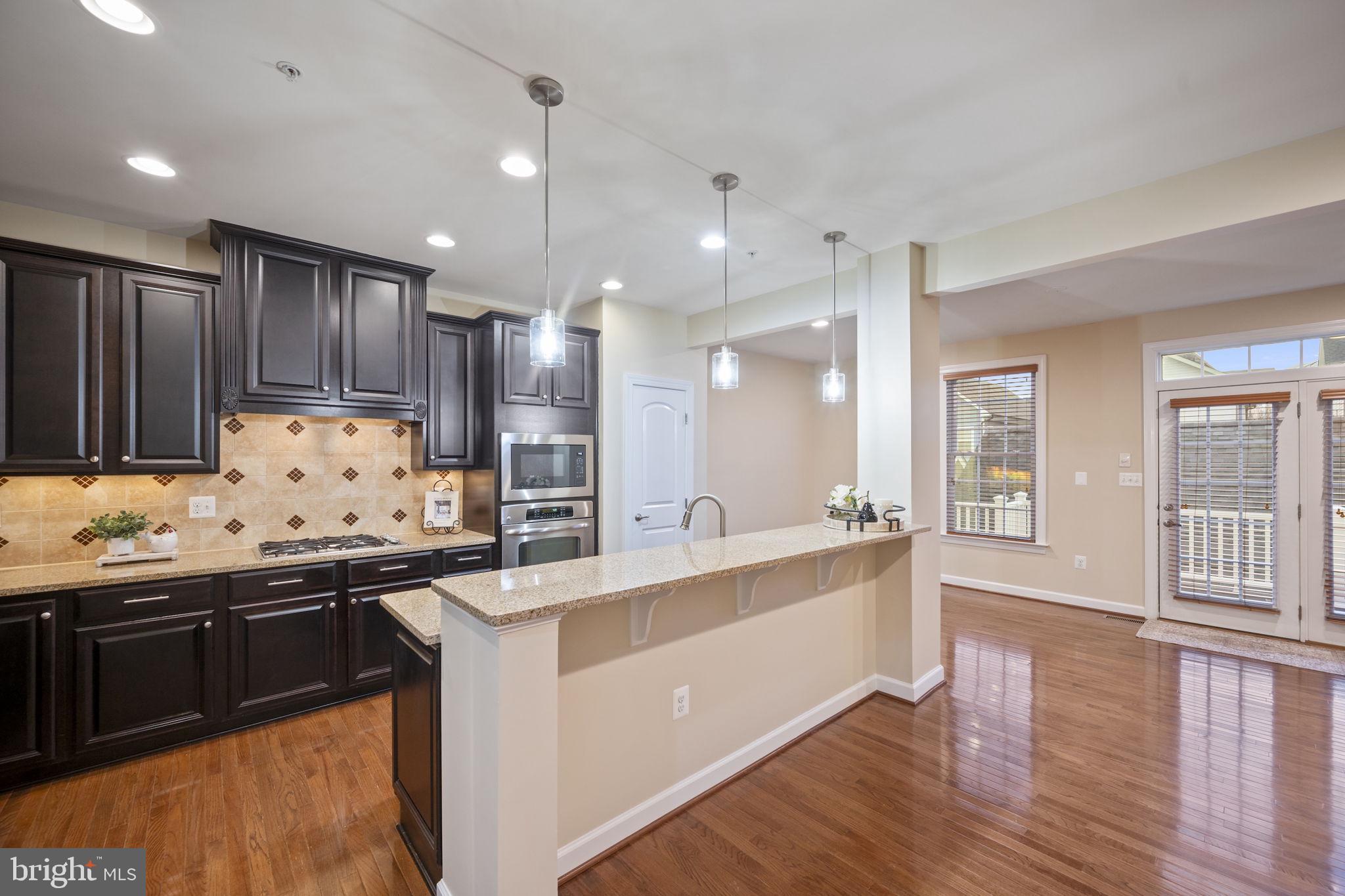 8976 Tawes Street Fulton, MD 20759 - Photo 16 of 65 a kitchen with stainless steel appliances granite countertop a sink stove and refrigerator
