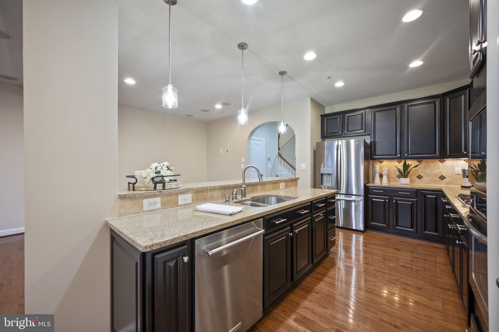 8976 Tawes Street Fulton, MD 20759 - Photo 17 of 65 a kitchen with stainless steel appliances granite countertop a sink a stove and a refrigerator