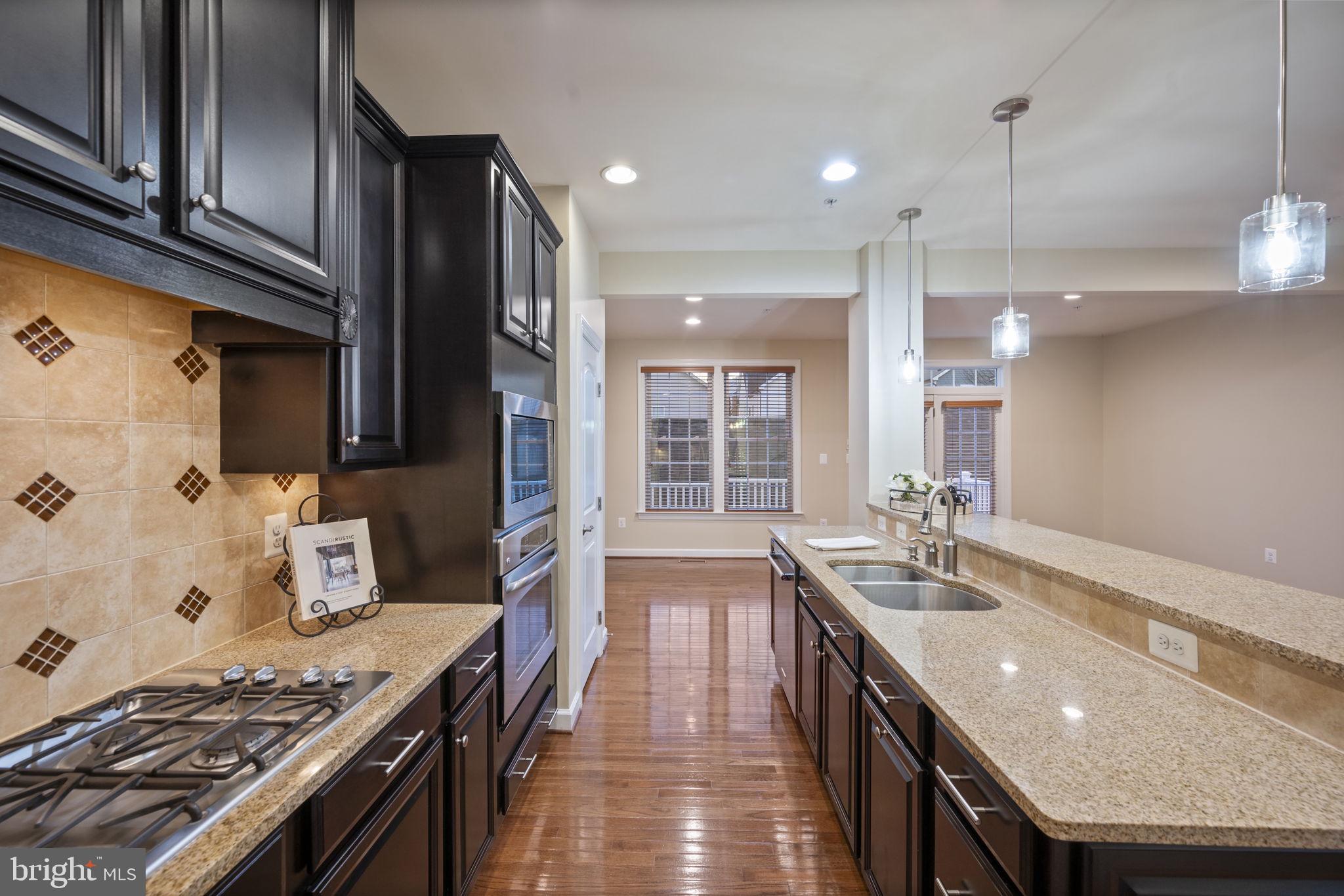 8976 Tawes Street Fulton, MD 20759 - Photo 18 of 65 a kitchen with granite countertop a stove and a sink
