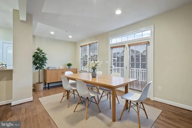 a view of a room wooden floor staircase and kitchen view