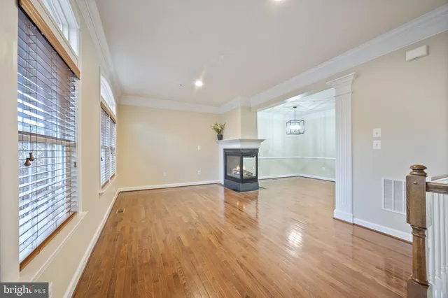 an empty room with a ceiling fan and a window
