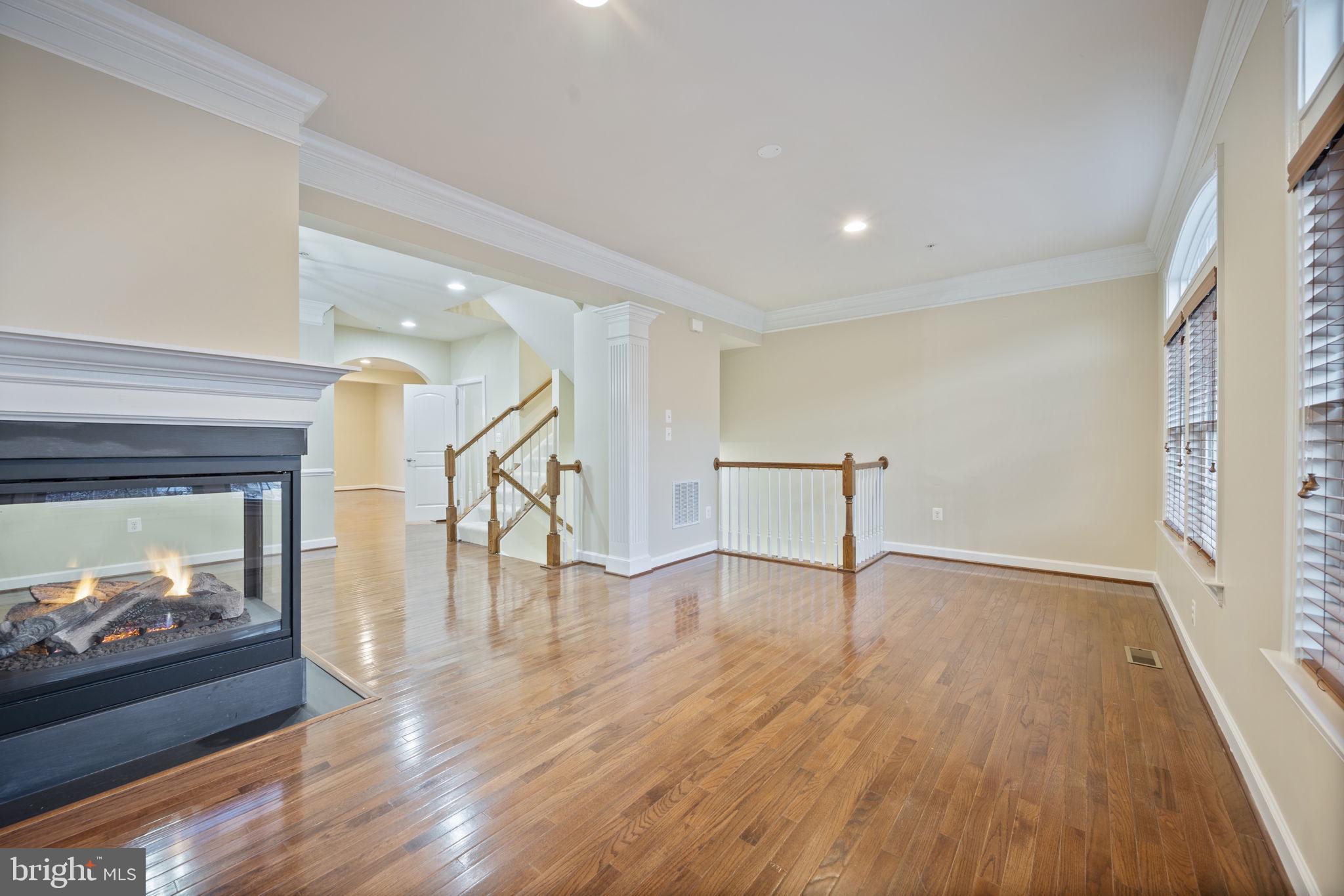 8976 Tawes Street Fulton, MD 20759 - Photo 32 of 65 a view of empty room with wooden floor and fireplace