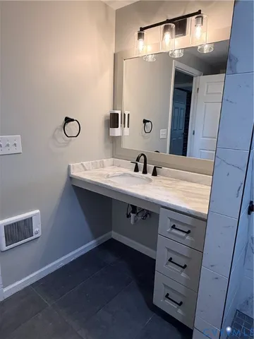 a bathroom with a sink vanity and a mirror