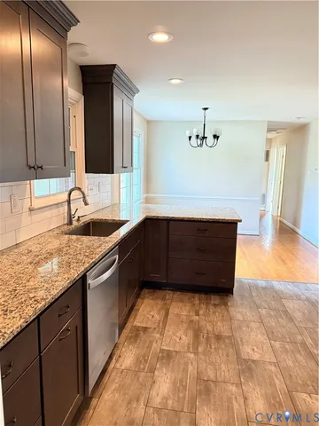 a kitchen with granite countertop a sink and a refrigerator