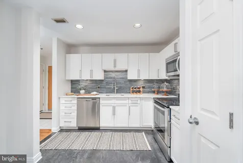 a kitchen with a white cabinets and white appliances