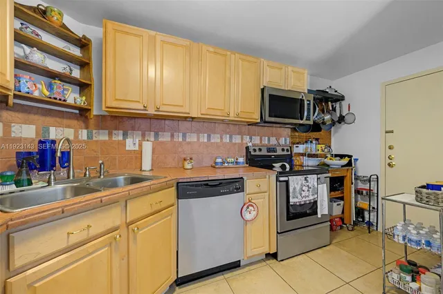 a kitchen with stainless steel appliances granite countertop a stove microwave and cabinets