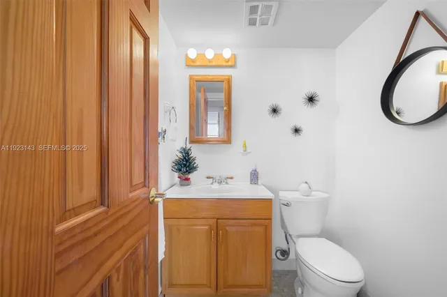 a bathroom with a sink a toilet and shower curtain