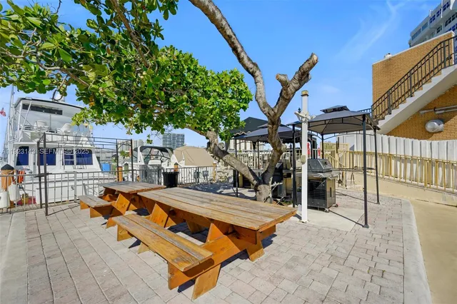 a backyard of a house with barbeque oven table and chairs