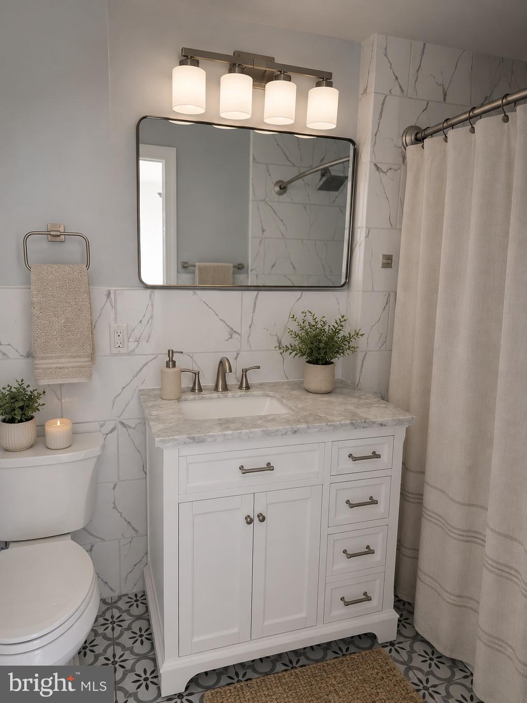 5925 Ridge Avenue, Unit 5 Philadelphia, PA 19128 - Photo 7 of 31 a bathroom with a granite countertop toilet sink and mirror
