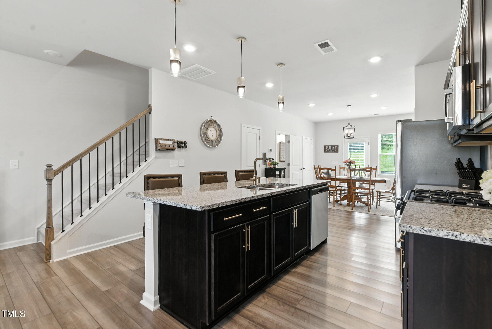 a kitchen with a stove and a wooden floor