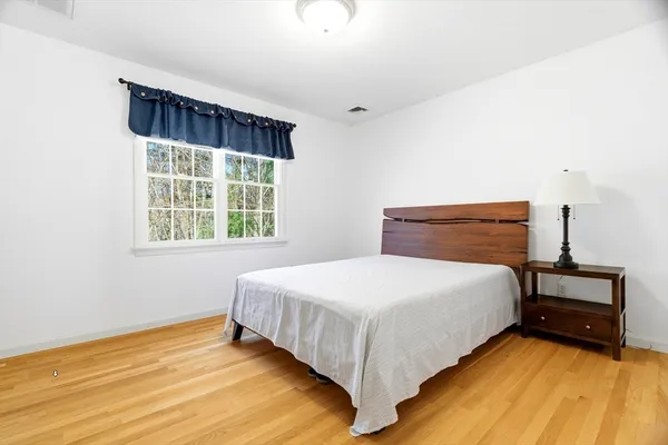 a bedroom with a bed and window