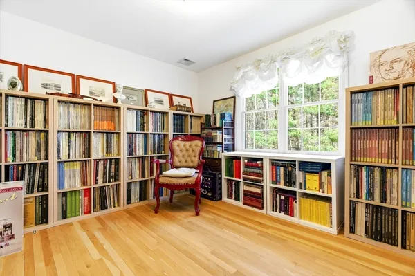 a room with lots of furniture and a book shelf