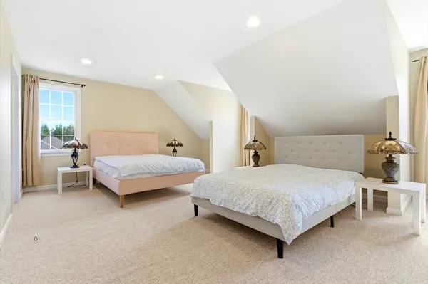 a bedroom with a bed and a couch