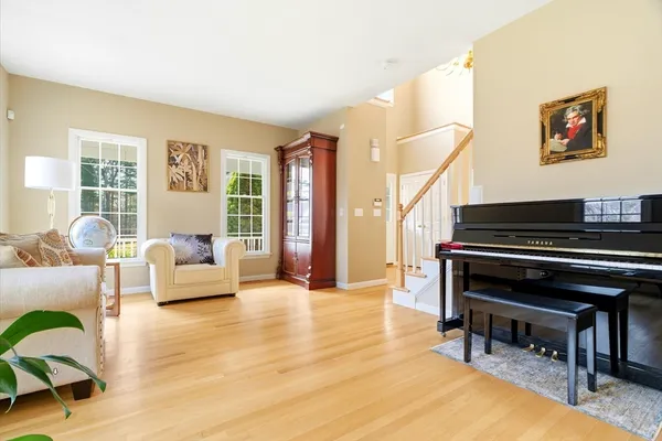 a living room with furniture and a piano