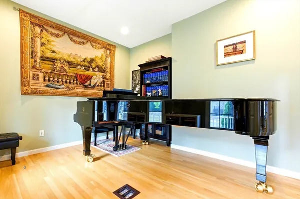a living room with stainless steel appliances furniture and a flat screen tv